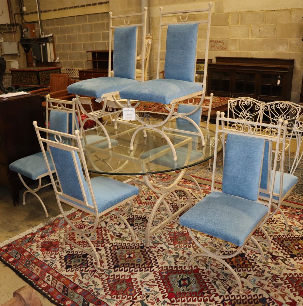 An enamelled metal dining suite comprising a circular glass-topped table and a set of eight chairs, table 138cm diameter